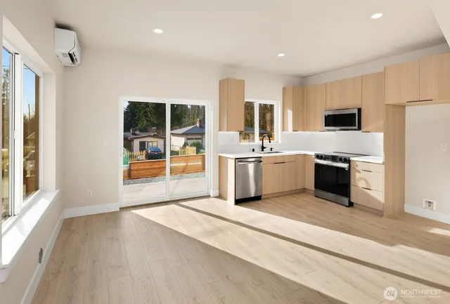a view of a kitchen with a stove cabinets and a wooden floor