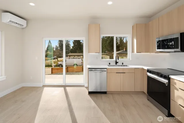 a kitchen with a sink and a stove top oven
