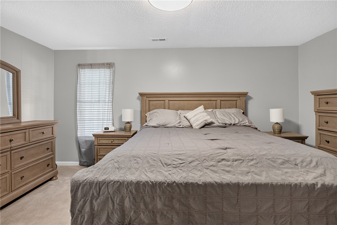 3336 Centerville Road Anderson, SC 29625 - Photo 21 of 50 A tranquil primary bedroom with soft carpeting and natural wood furnishings awaits.