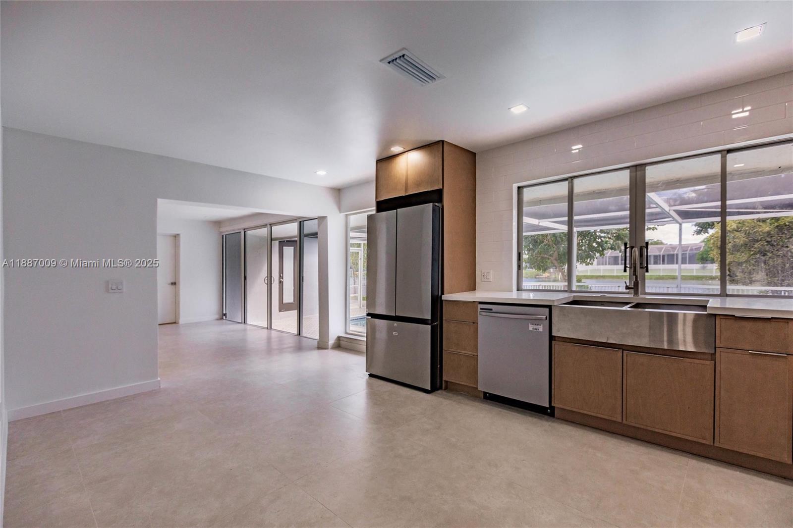 10760 Northwest 29th Manor Sunrise, FL 33322 - Photo 15 of 38 a large kitchen with a large window and refrigerator