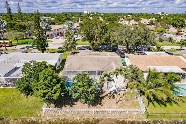 an aerial view of residential houses with outdoor space and street view