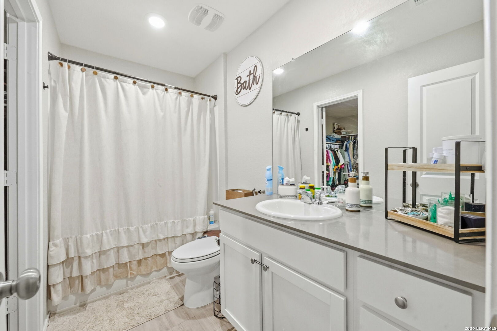 140 Maverick Cove Pleasanton, TX 78064 - Photo 15 of 26 a bathroom with a double vanity sink toilet and a mirror