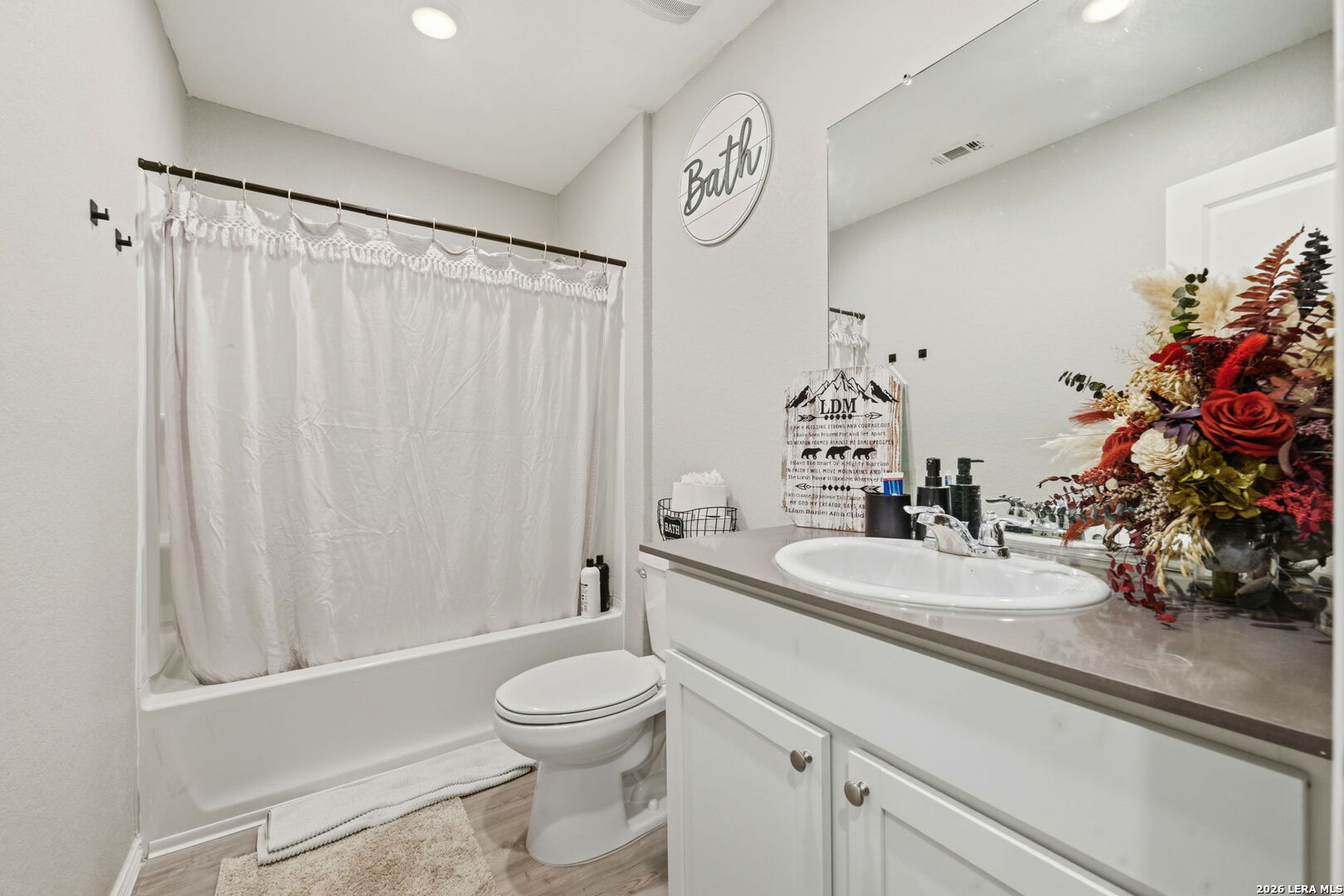 140 Maverick Cove Pleasanton, TX 78064 - Photo 17 of 26 a bathroom with a sink a toilet and a mirror