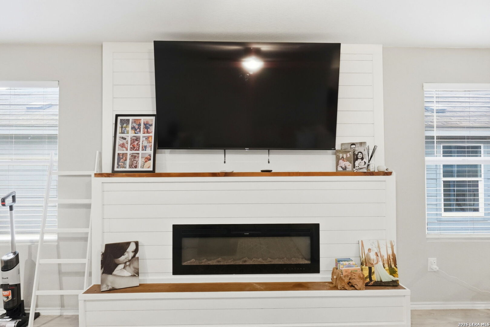 140 Maverick Cove Pleasanton, TX 78064 - Photo 4 of 26 a living room with a fireplace and a flat screen tv
