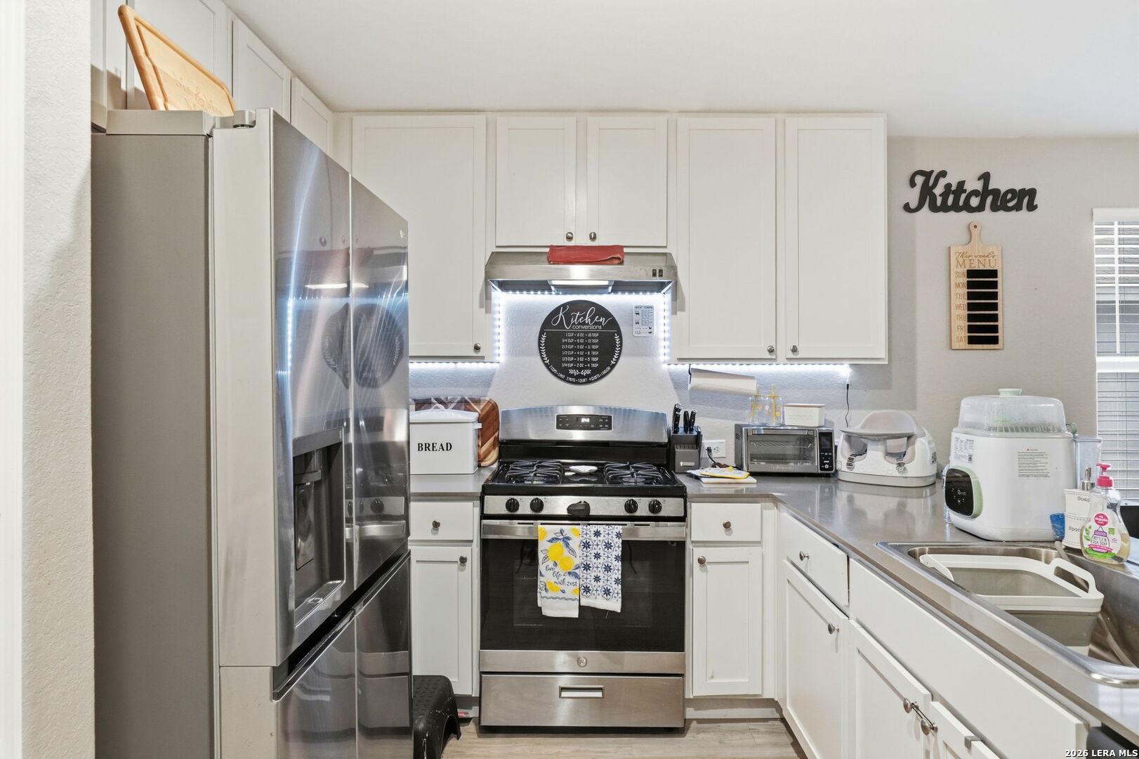 140 Maverick Cove Pleasanton, TX 78064 - Photo 10 of 26 a kitchen with stainless steel appliances granite countertop a stove a refrigerator and a sink