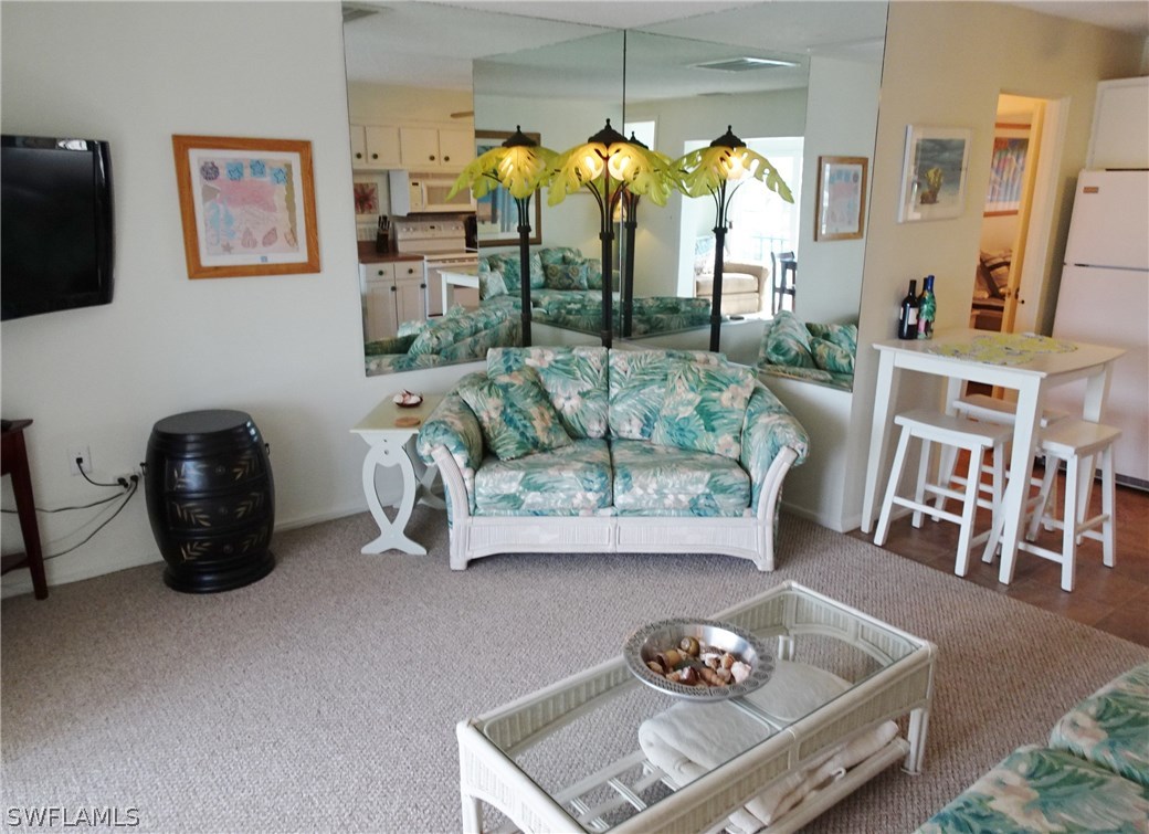 3215 Stringfellow Road, Unit 201 St. James City, FL 33956 - Photo 11 of 25 a living room with furniture and a flat screen tv