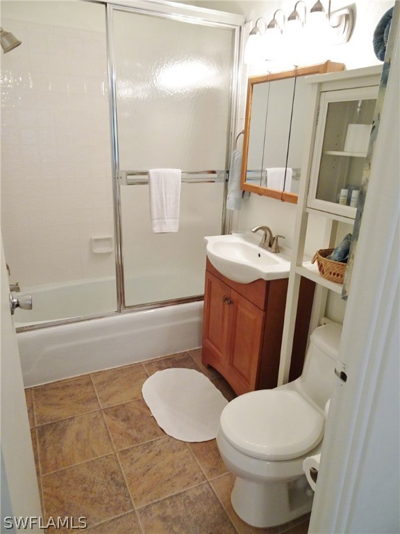 3215 Stringfellow Road, Unit 201 St. James City, FL 33956 - Photo 13 of 25 a bathroom with a sink a toilet a mirror and shower