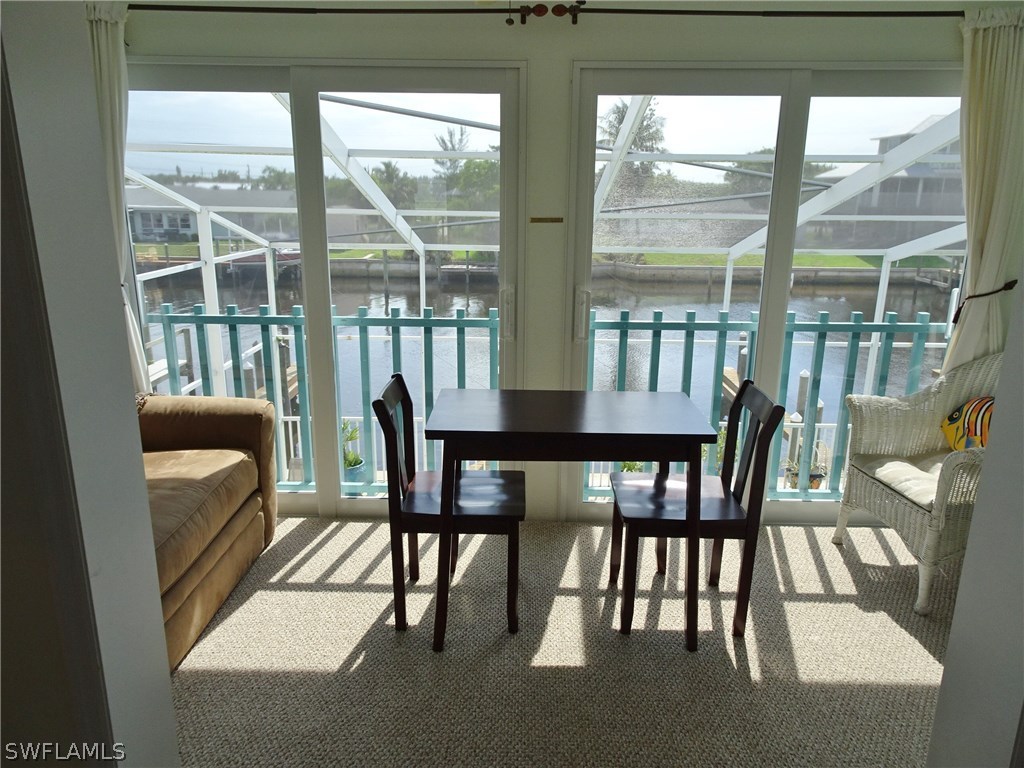 3215 Stringfellow Road, Unit 201 St. James City, FL 33956 - Photo 2 of 25 a view of a dining room with furniture window and outside view