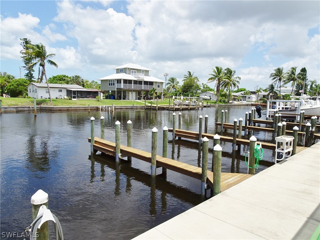 3215 Stringfellow Road, Unit 201 St. James City, FL 33956 - Photo 23 of 25 a view of a lake with a table and chairs
