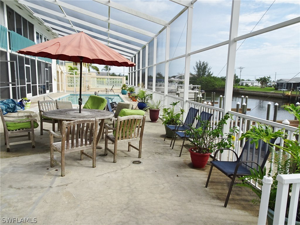 3215 Stringfellow Road, Unit 201 St. James City, FL 33956 - Photo 25 of 25 a dining area with furniture and outdoor view