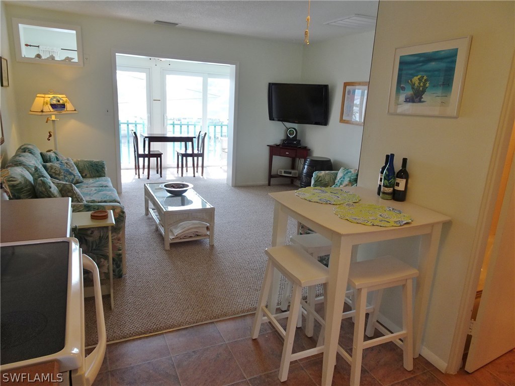 3215 Stringfellow Road, Unit 201 St. James City, FL 33956 - Photo 8 of 25 a dining room with furniture and window