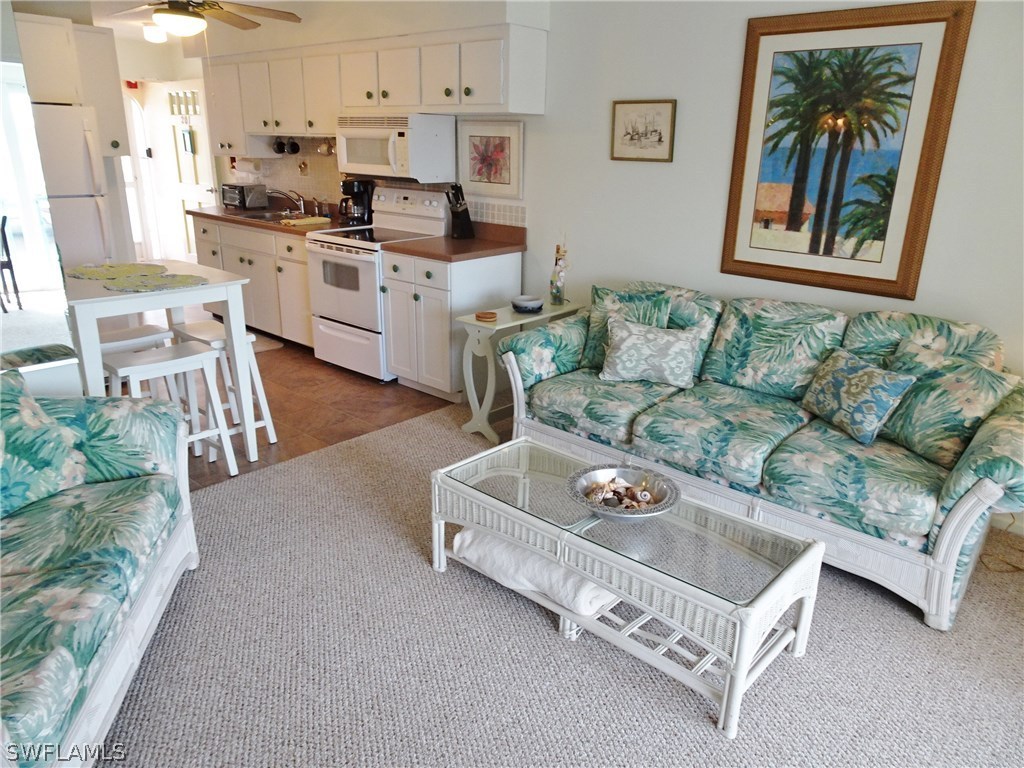 3215 Stringfellow Road, Unit 201 St. James City, FL 33956 - Photo 10 of 25 a living room with furniture and a kitchen