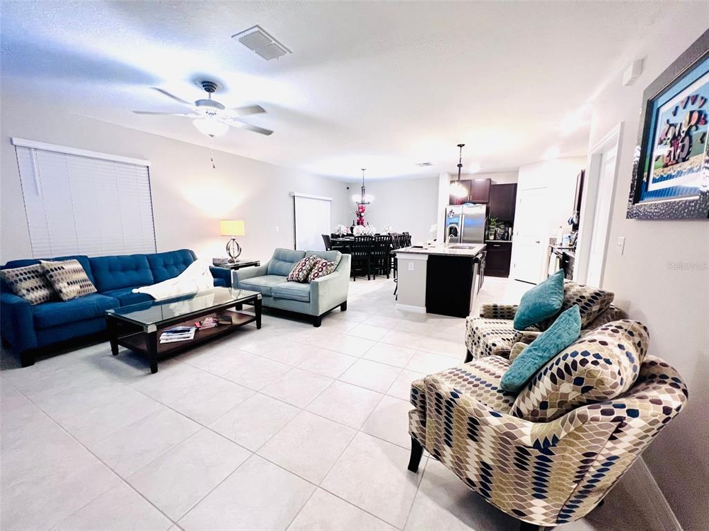 2170 Shining Azul Way Lutz, FL 33558 - Photo 5 of 16 a living room with furniture and a chandelier