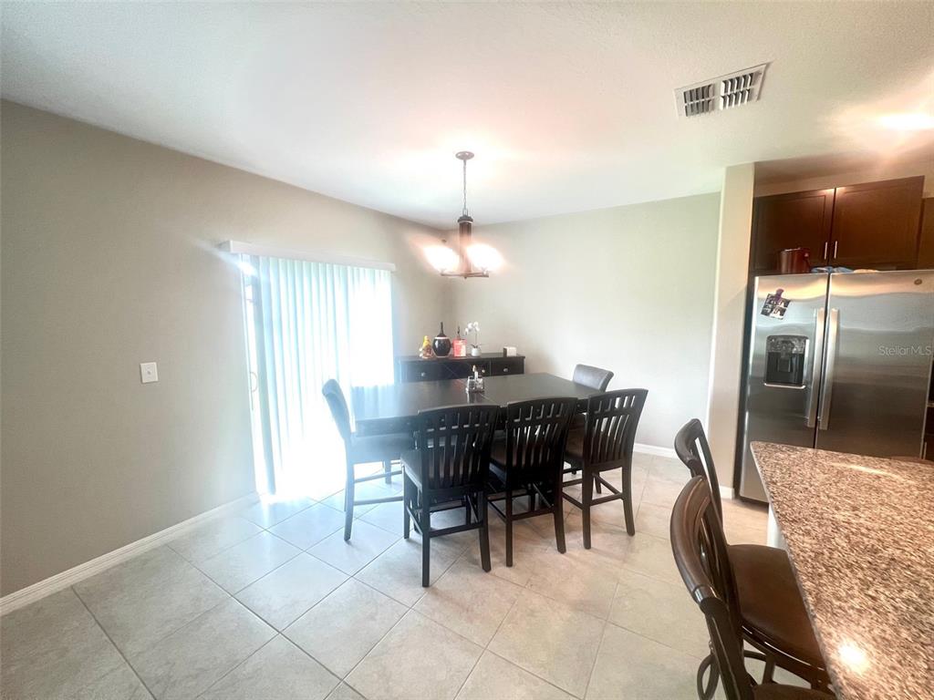 2170 Shining Azul Way Lutz, FL 33558 - Photo 6 of 16 a dining room with furniture and window
