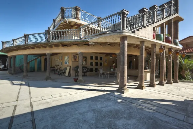 a dining room with furniture a chandelier and wooden floor