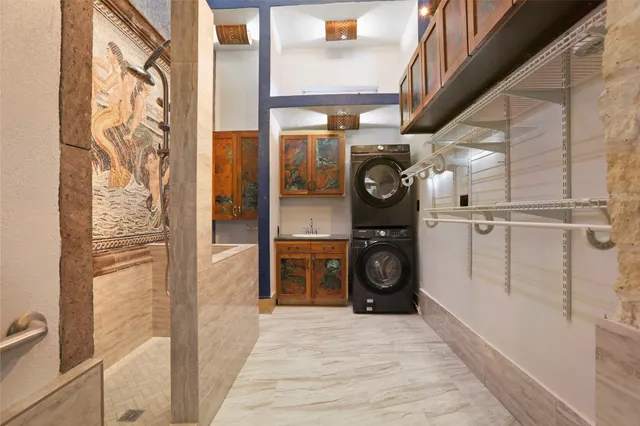 a utility room with sink dryer and washer