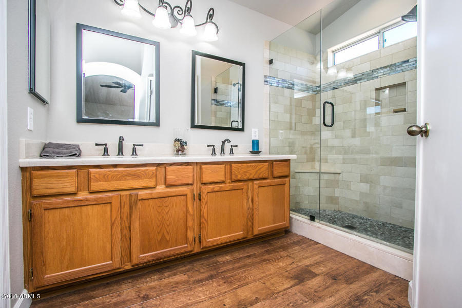 4632 East Danbury Road Phoenix, AZ 85032 - Photo 7 of 9 a bathroom with a double vanity sink mirror and shower