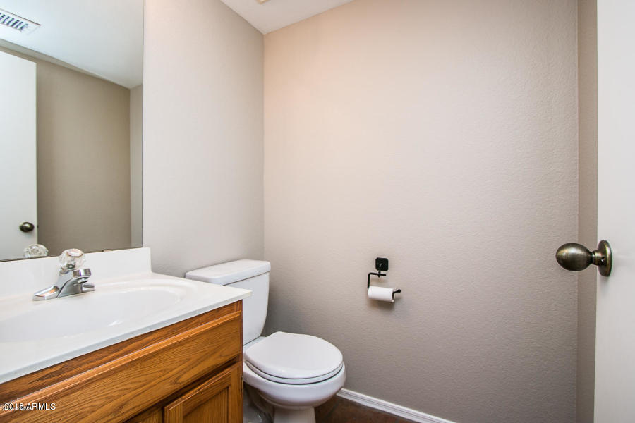 4632 East Danbury Road Phoenix, AZ 85032 - Photo 8 of 9 a bathroom with a sink a toilet and a mirror