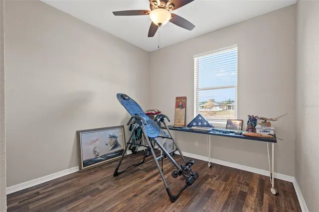 a view of a workspace with furniture and a window