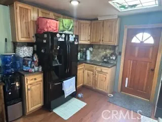 a kitchen with stainless steel appliances granite countertop a refrigerator and a stove