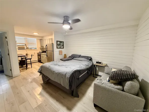 a spacious bedroom with a bed couch and a window