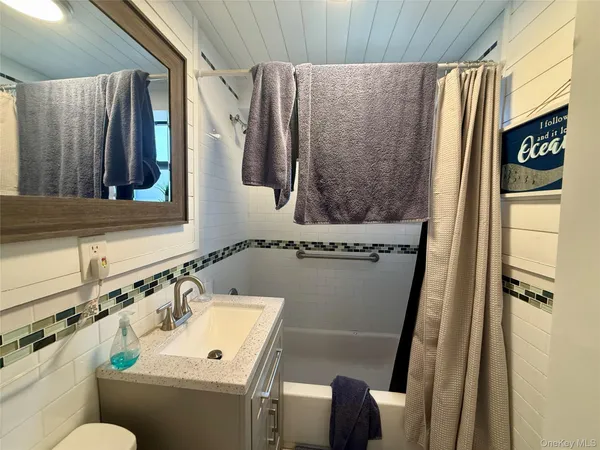 a bathroom with a sink and mirror