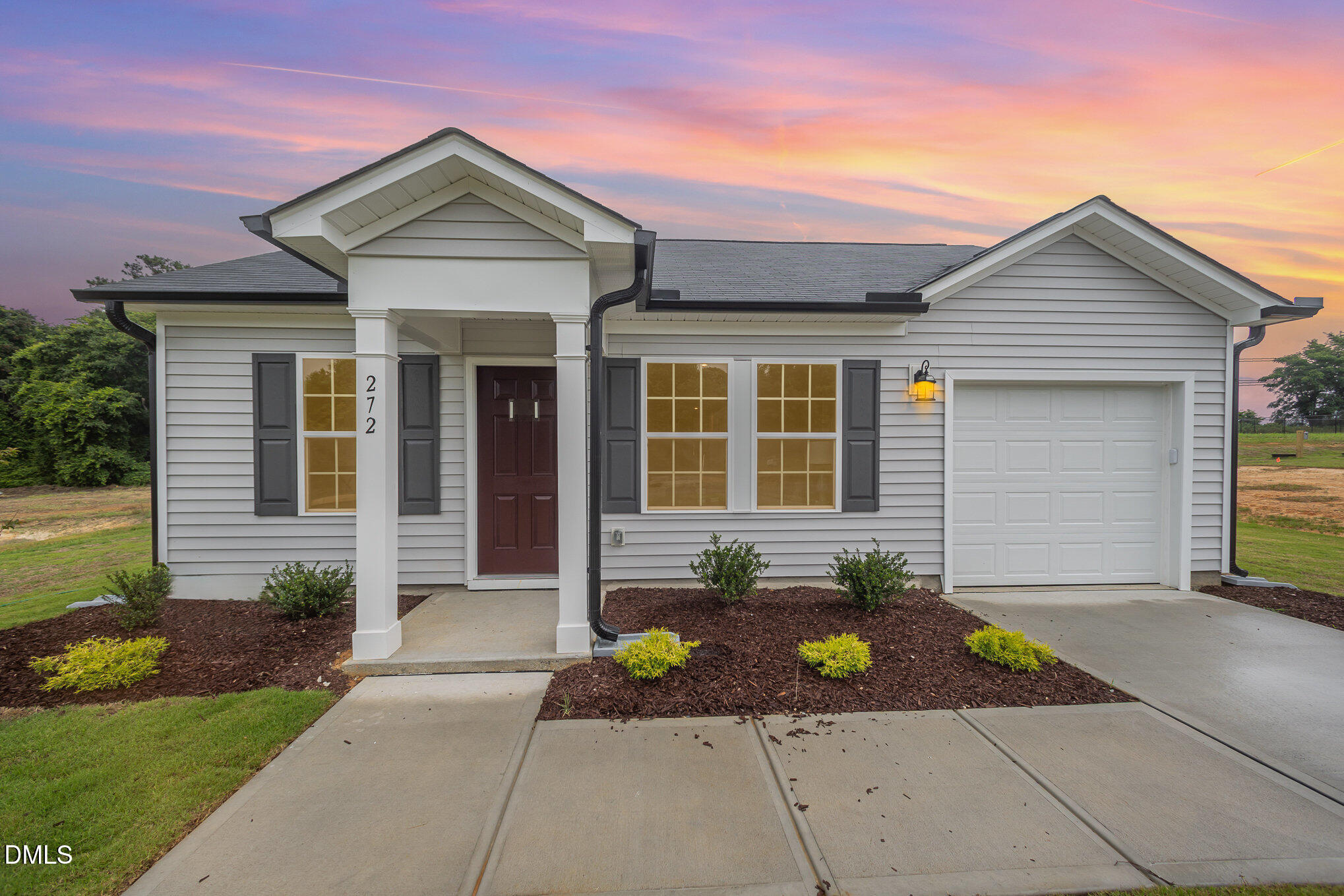 a front view of a house with a garden