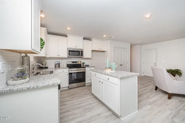 a kitchen with a sink stove top oven and microwave
