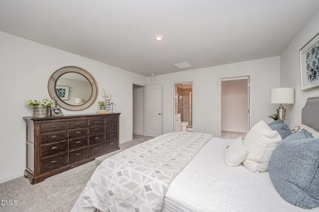 a bedroom with a bed and a dresser