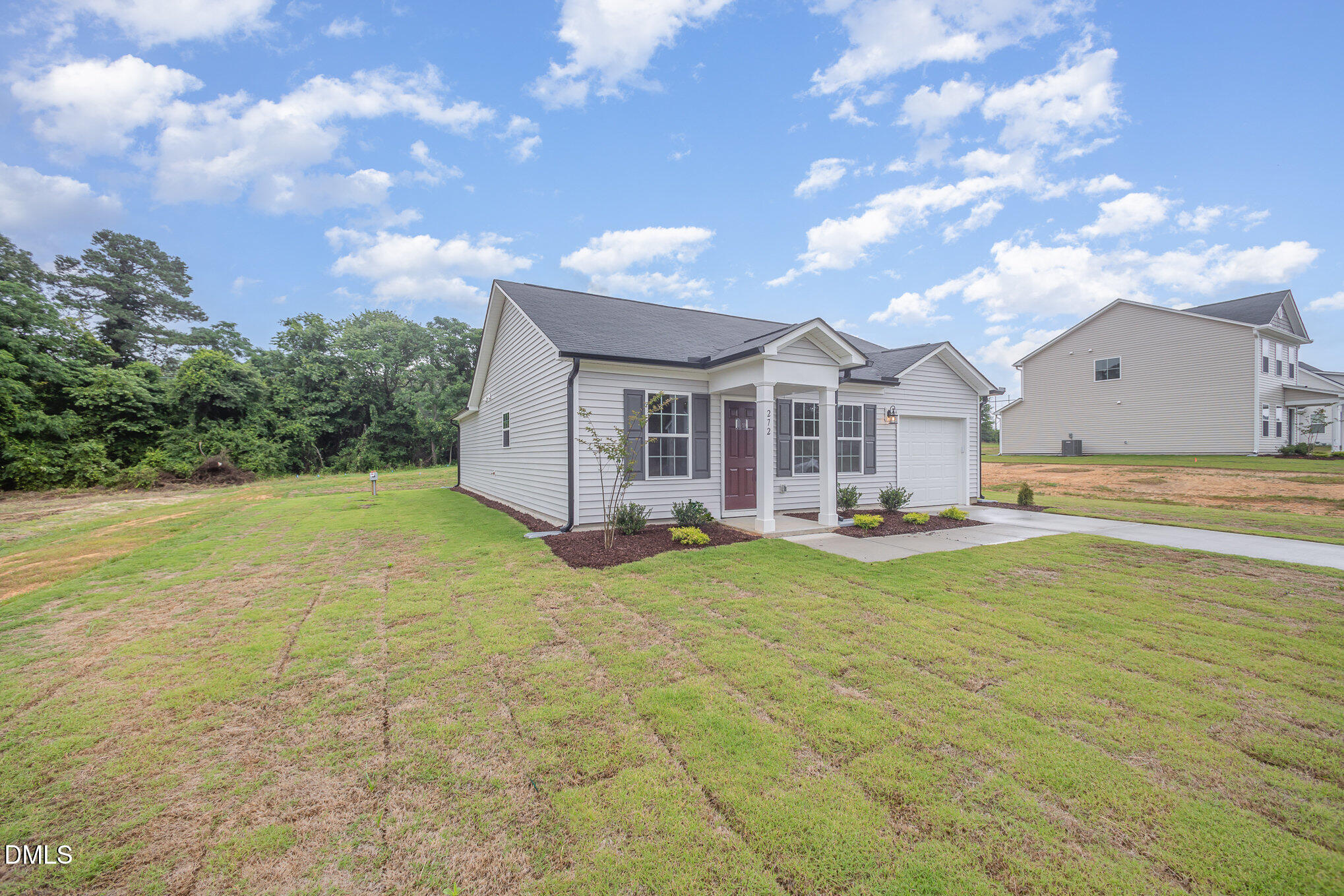 272 Johnson Rdg Way, Unit 1 Four Oaks, NC 27524 - Photo 5 of 27 a view of a house with backyard and sitting area