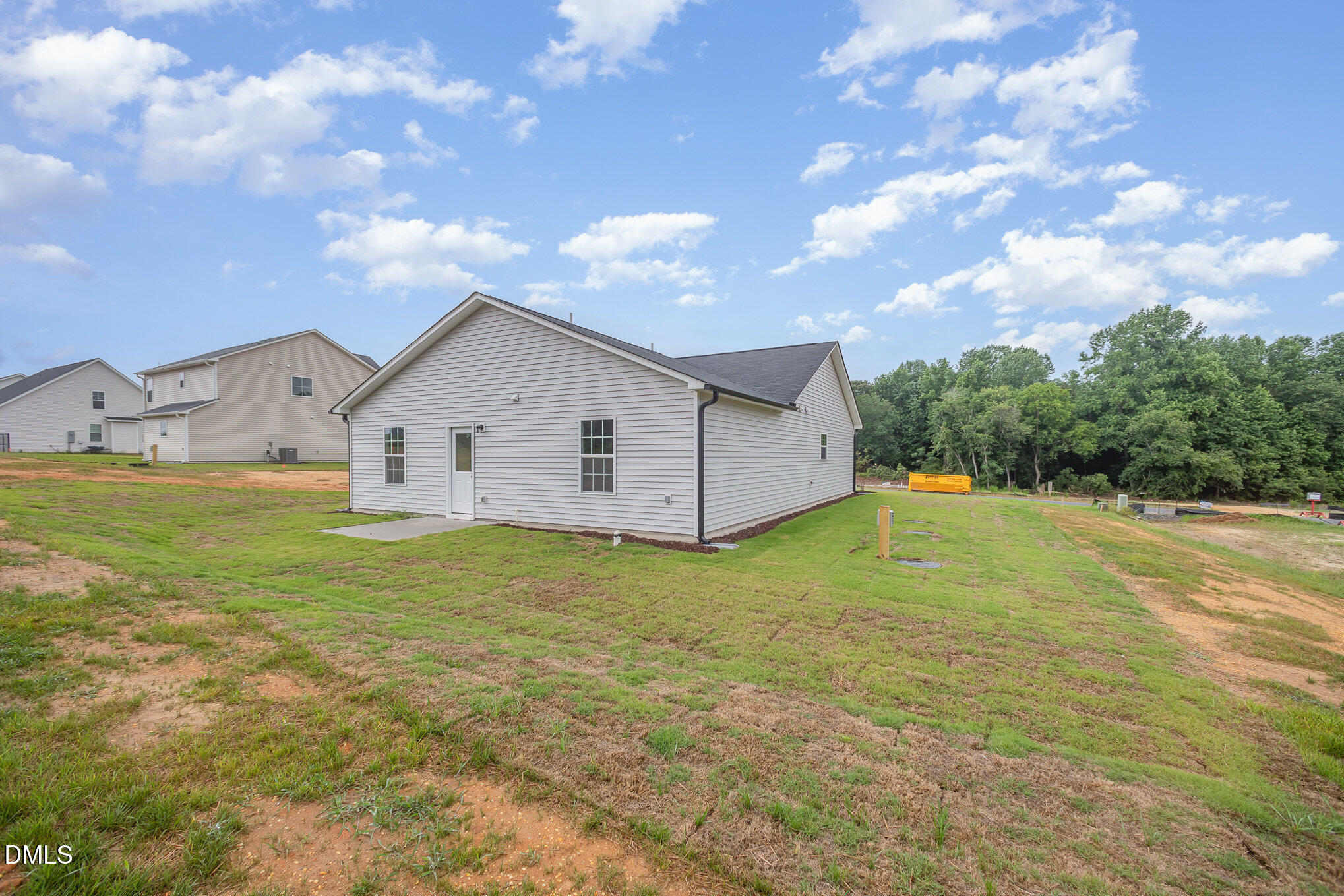 272 Johnson Rdg Way, Unit 1 Four Oaks, NC 27524 - Photo 7 of 27 a view of a white house with a yard