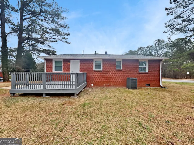 a view of a house with a yard and deck
