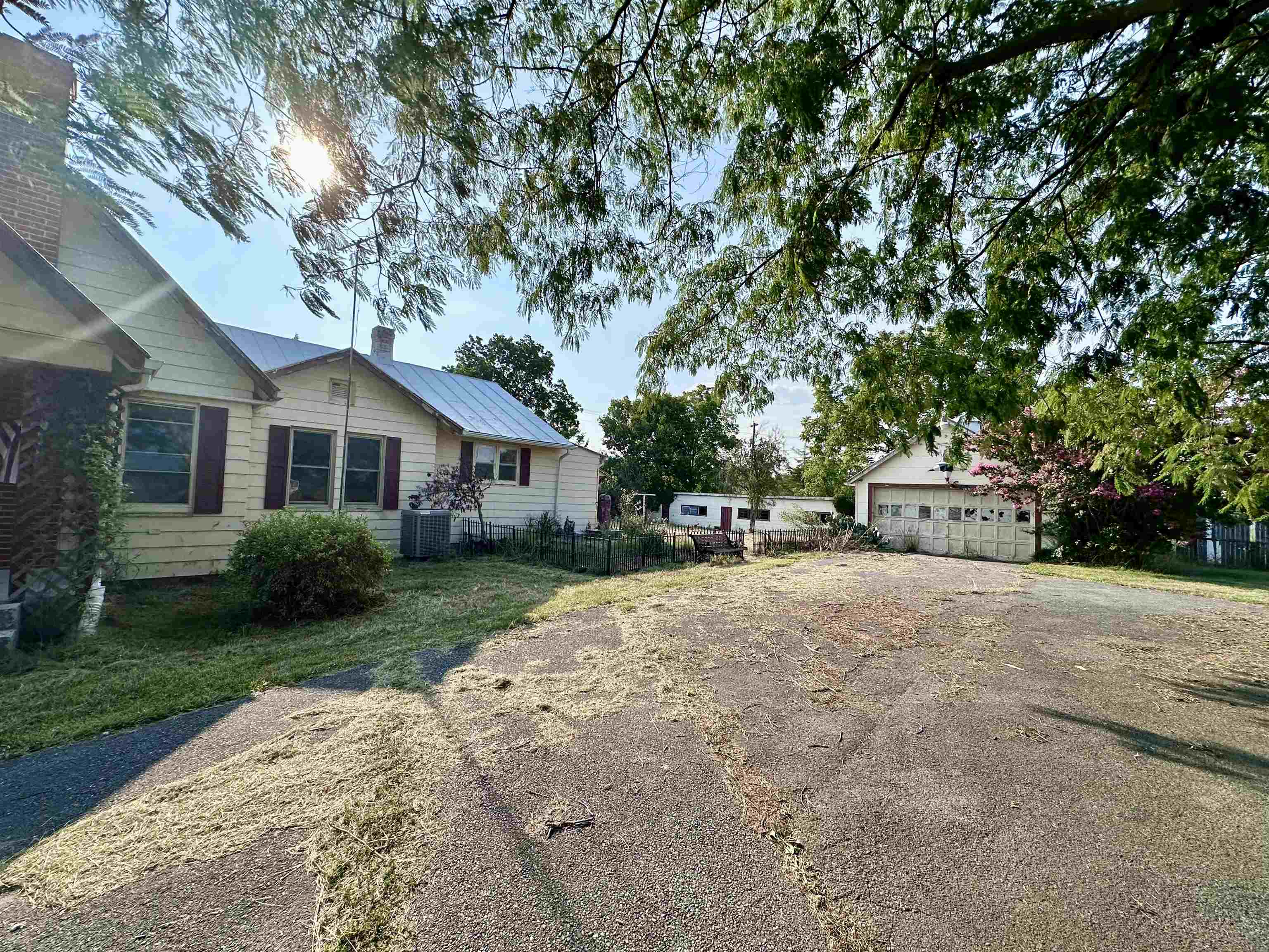 a front view of a house with a yard and trees