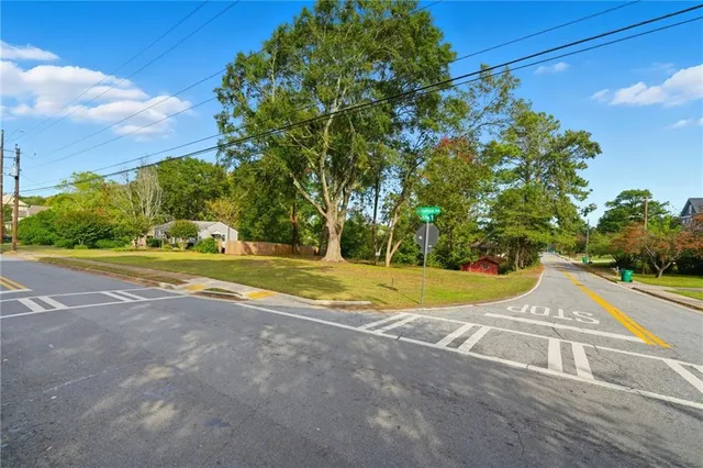 a view of yard with swimming pool and green space