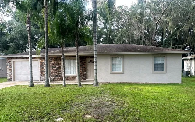 a view of a house with pool and garden