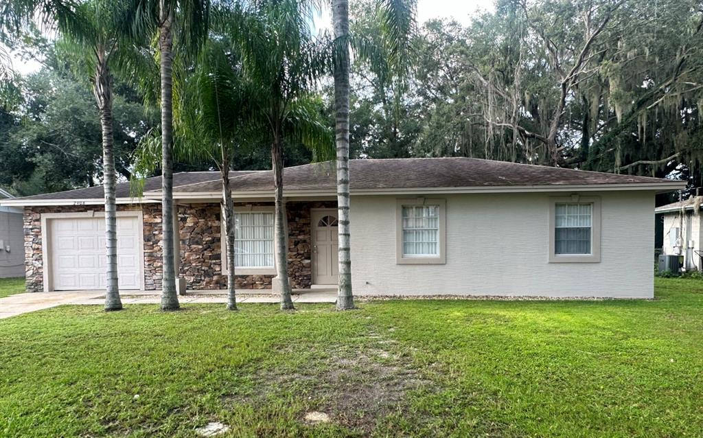a view of a house with pool and garden
