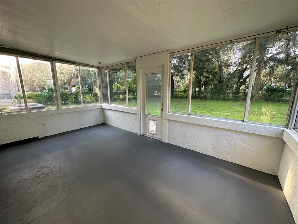 2906 Garden Road Eustis, FL 32726 - Photo 11 of 12 a view of an empty room with large windows