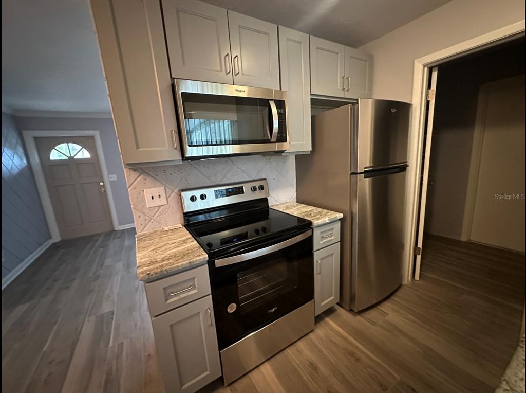 2906 Garden Road Eustis, FL 32726 - Photo 5 of 12 a kitchen with a refrigerator stove and microwave
