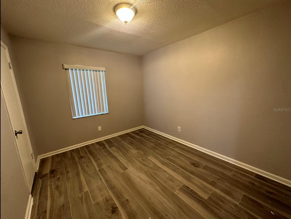 2906 Garden Road Eustis, FL 32726 - Photo 8 of 12 a view of empty room with wooden floor