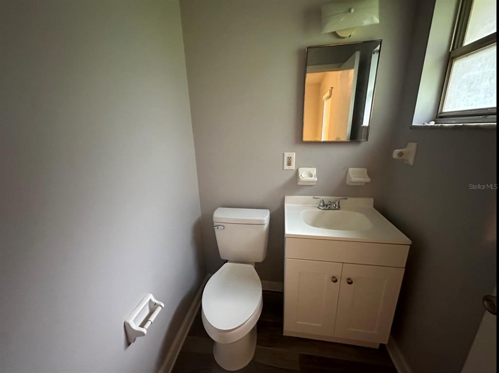 2906 Garden Road Eustis, FL 32726 - Photo 10 of 12 a bathroom with a toilet sink and mirror