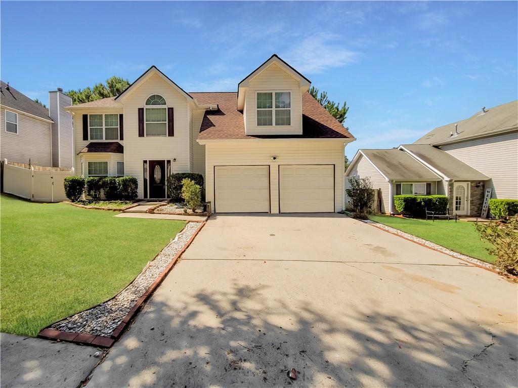 3942 Arabian Way Southwest Snellville, GA 30039 - Photo 1 of 1 a front view of a house with a yard and garage