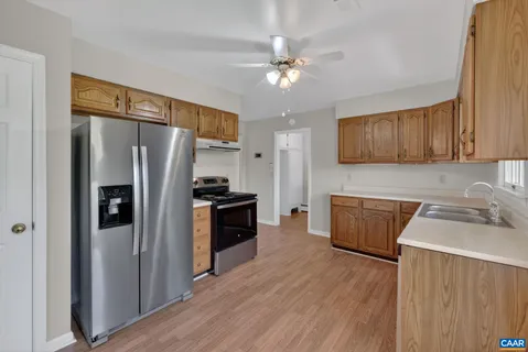 a kitchen with stainless steel appliances a refrigerator sink and cabinets