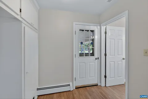 a view of an entryway with wooden floor