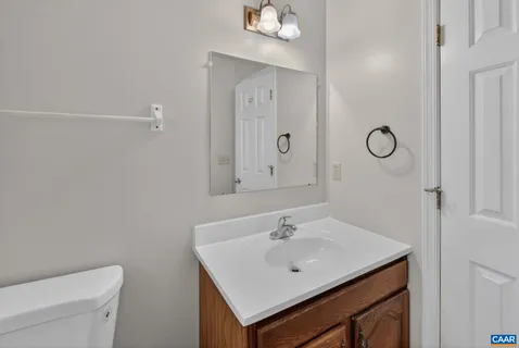 a bathroom with a sink toilet and vanity