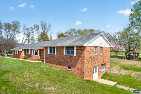 a front view of a house with a yard and trees
