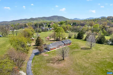 a view of a house with a yard and mountain