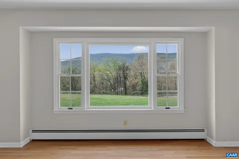 a view of room with window and a ceiling fan
