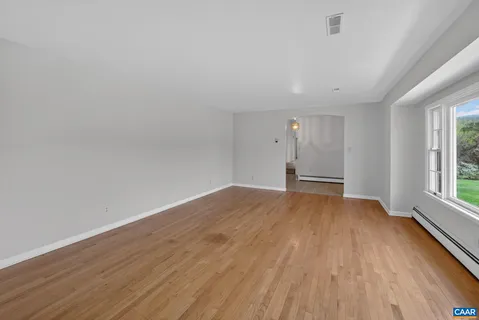 wooden floor in an empty room with a window