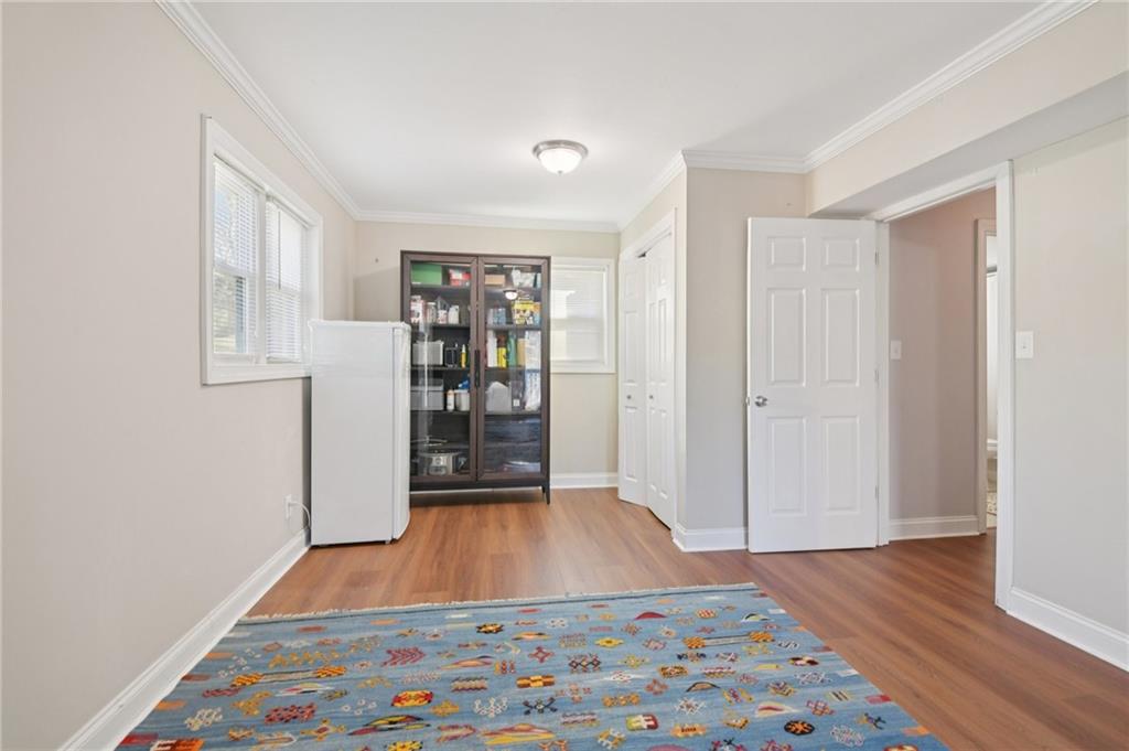 3459 Tulip Drive Decatur, GA 30032 - Photo 13 of 17 a room with wooden floor and a book shelf