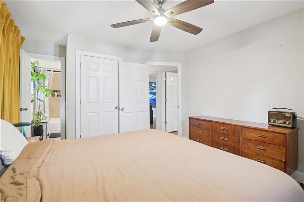 3459 Tulip Drive Decatur, GA 30032 - Photo 8 of 17 a bedroom with a bed and a chandelier